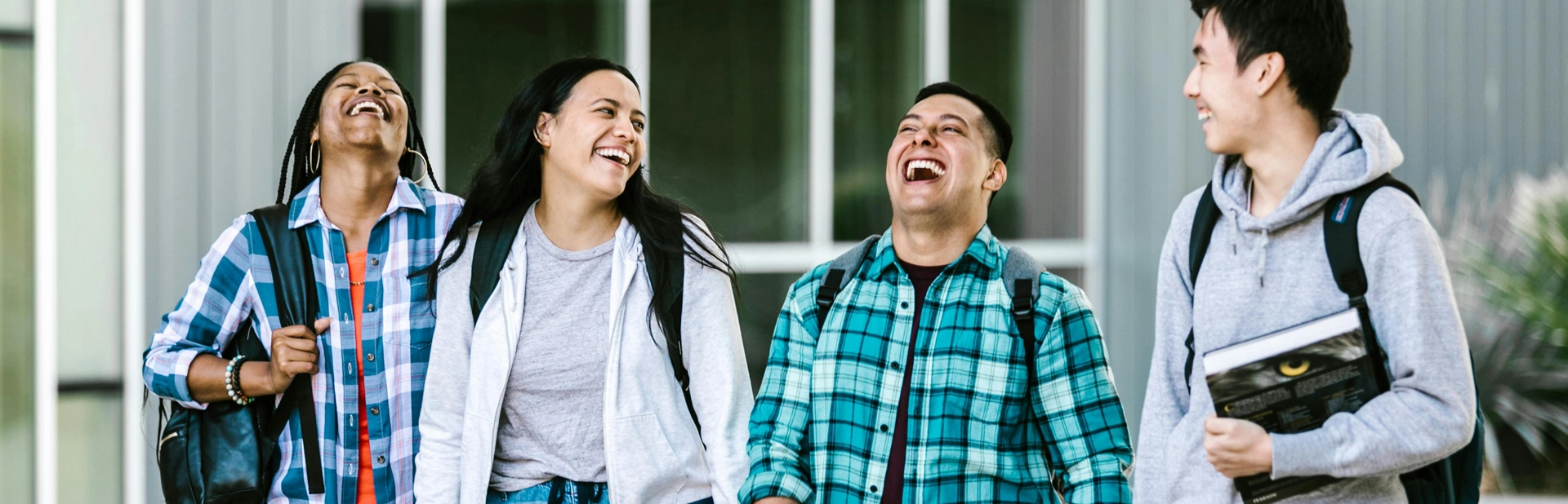 A man and woman laughing together outside.