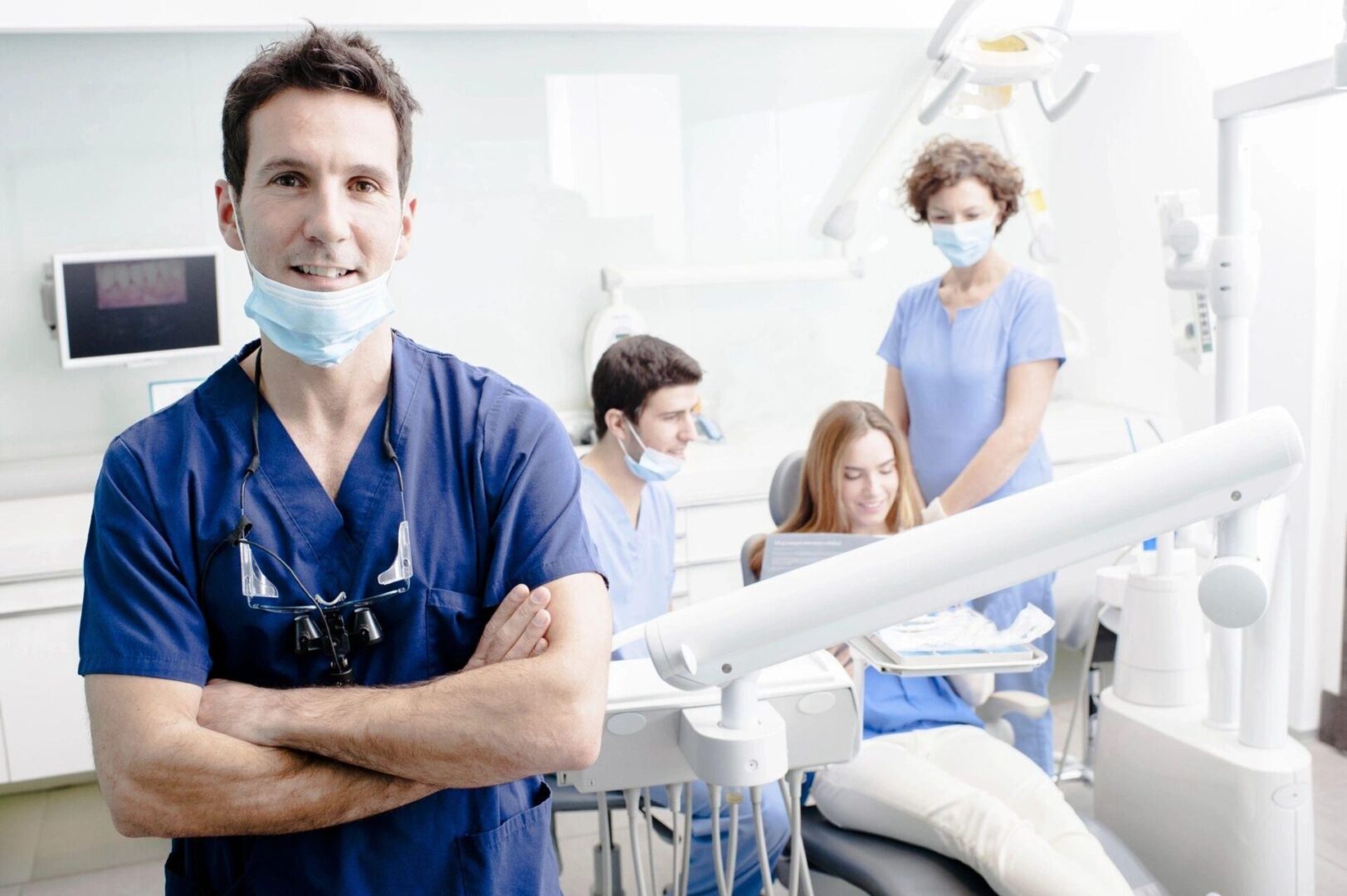 A dentist standing in front of other dentists.