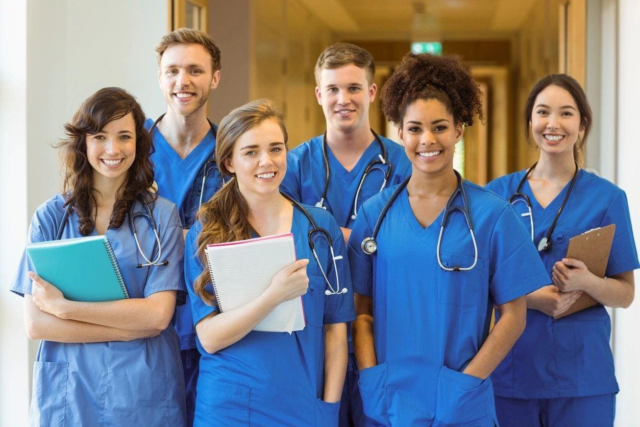 A group of doctors standing in front of a wall.